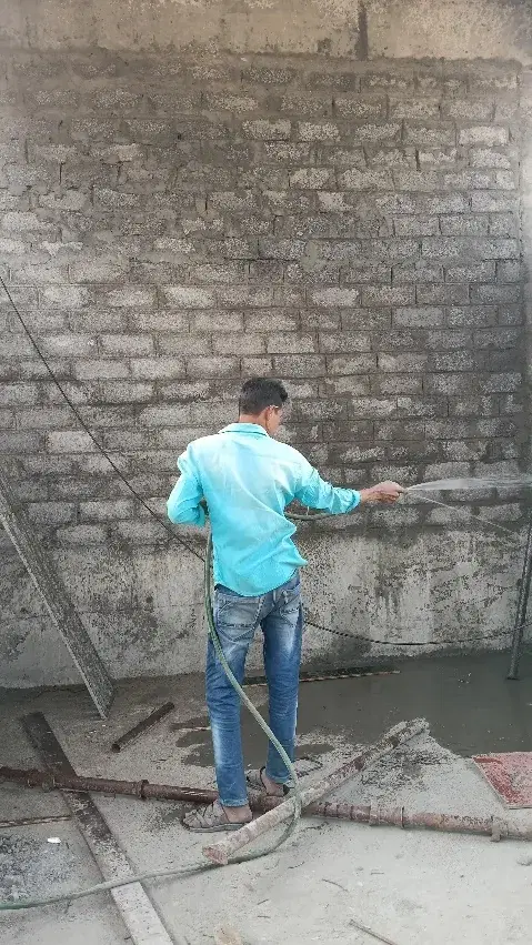 Worker finishing an interior wall at Gujarat Fluorochemicals